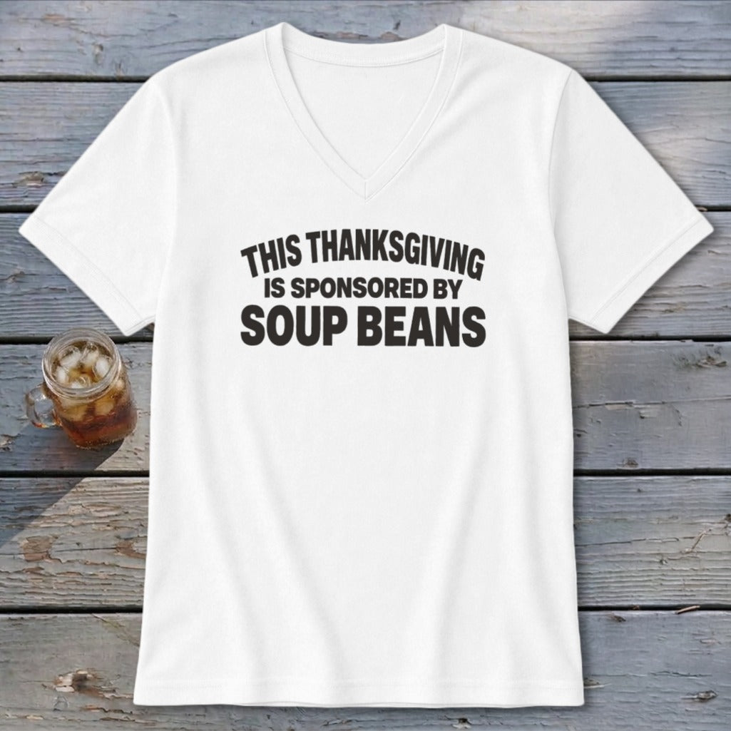 A white V-neck t-shirt with black text that reads, "THIS THANKSGIVING IS SPONSORED BY SOUP BEANS."