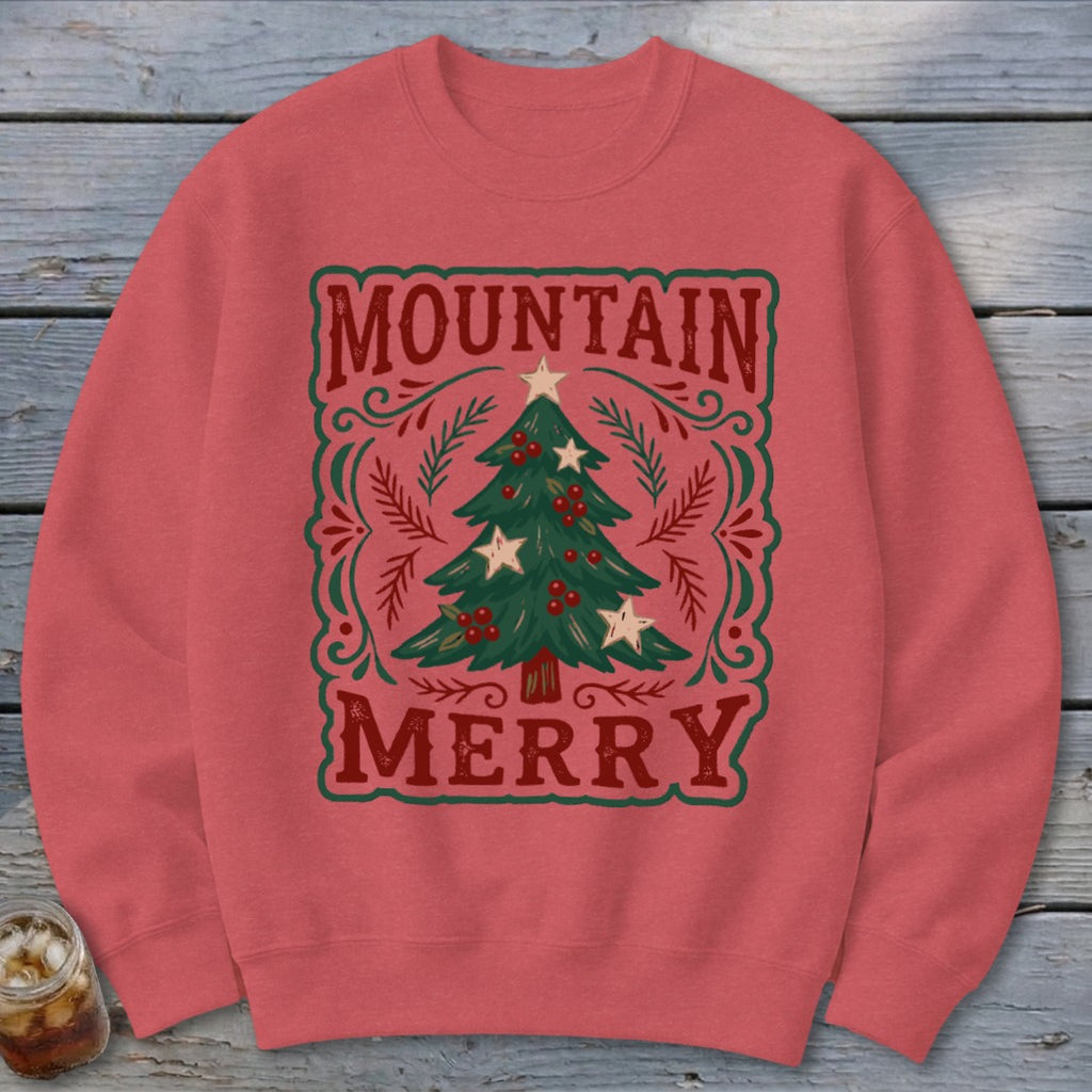 Red crewneck sweatshirt featuring a Christmas graphic with the text Mountain Merry surrounding a decorated tree.