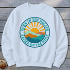 White crewneck sweatshirt featuring a circular graphic with mountains, a sun, and the text Born in the Holler Raised on the Ridge.