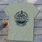 Light green t-shirt with Appalachian Born and Bred Still Standing logo.