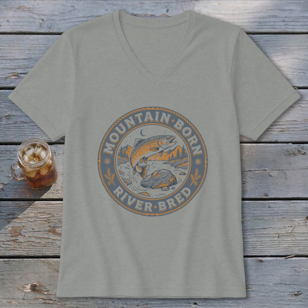 T-shirt with circular graphic of jumping trout, mountains, and text "MOUNTAIN BORN RIVER BRED".