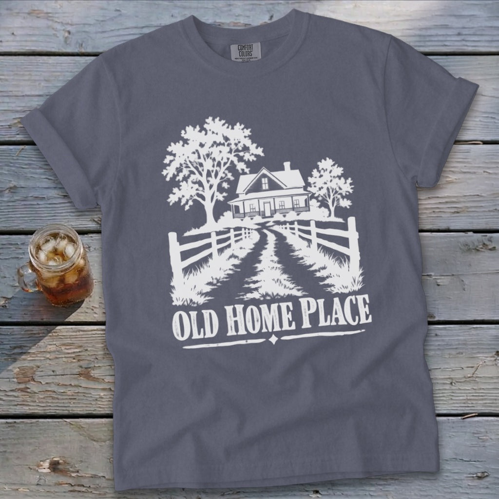 T-shirt graphic: white silhouette of a house, trees, fence, and text "OLD HOME PLACE".