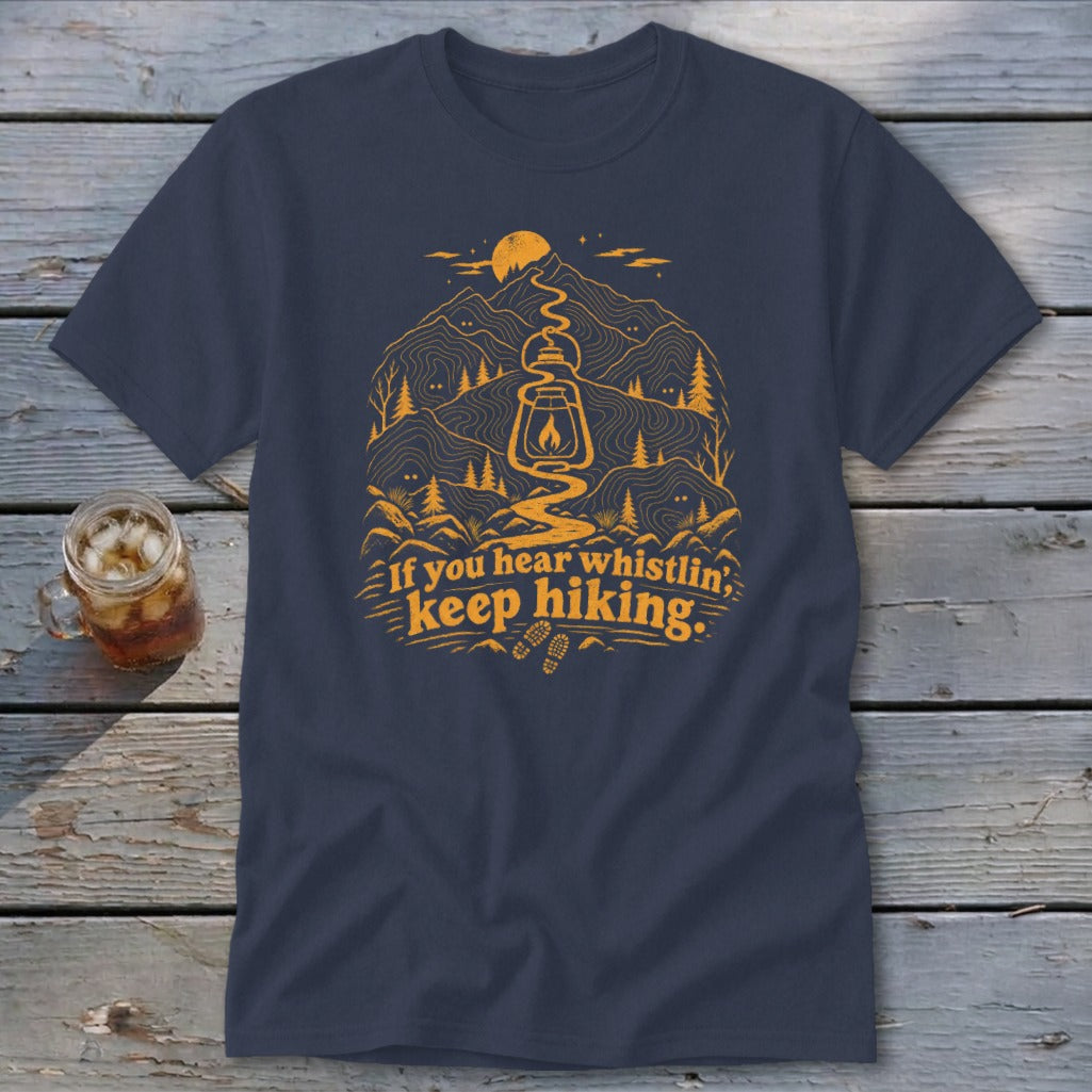Navy t-shirt with orange graphic of mountains, lantern, and text "If you hear whistlin', keep hiking."