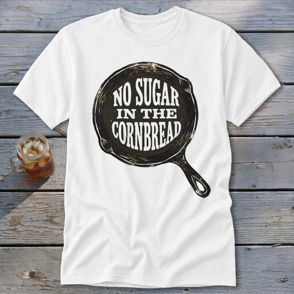 White t-shirt with graphic of a cast iron skillet saying "NO SUGAR IN THE CORNBREAD."