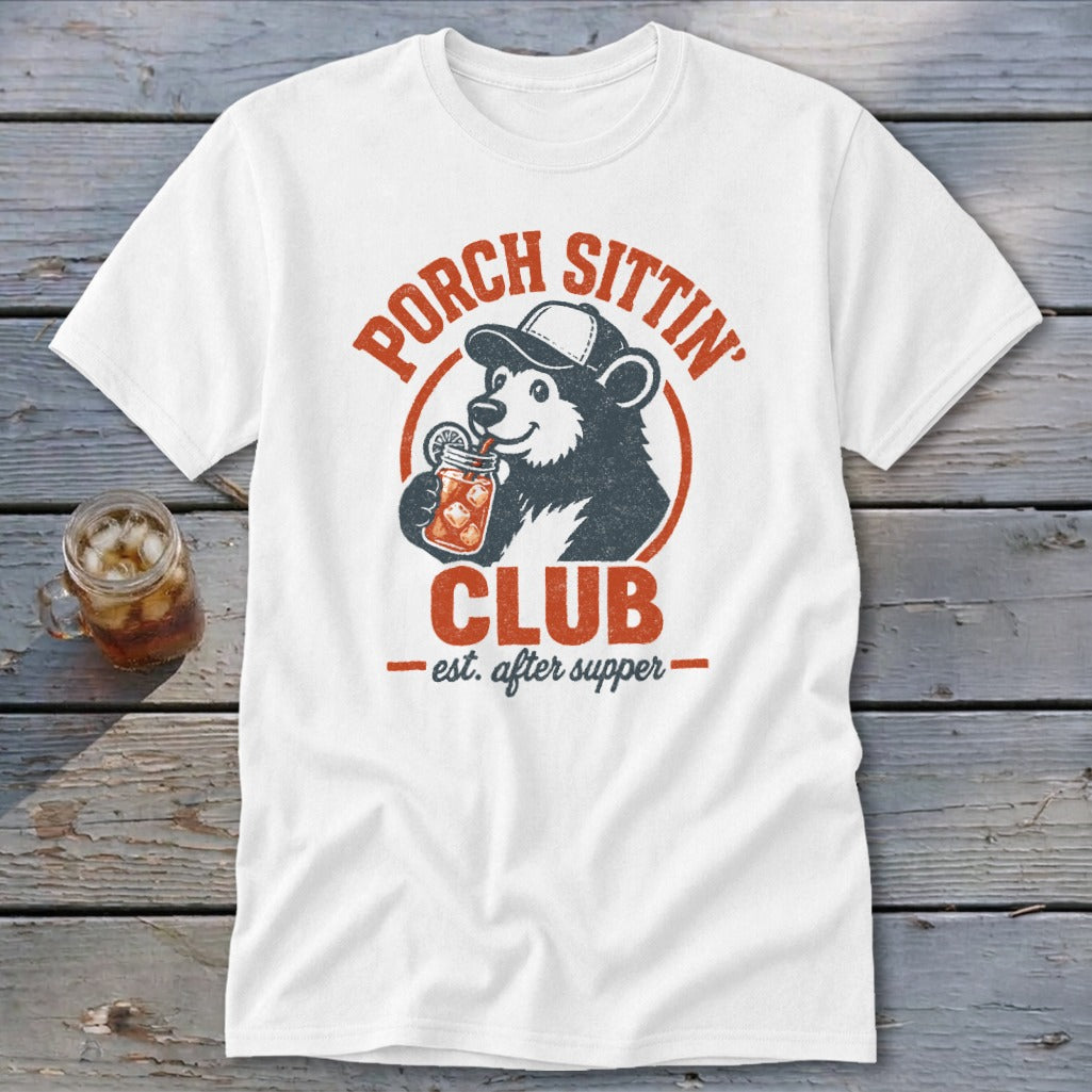 White t-shirt with a bear wearing a cap and drinking from a jar labeled "Porch Sittin' Club".