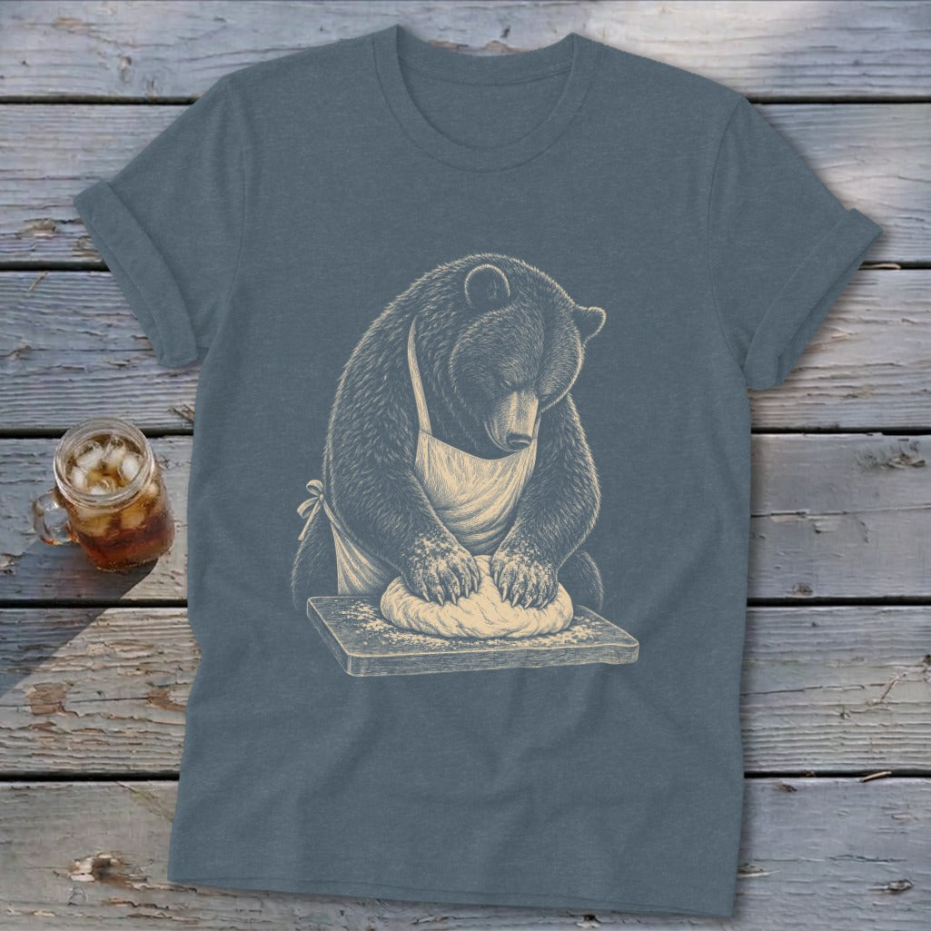 Bear wearing apron kneading dough on a wooden board.