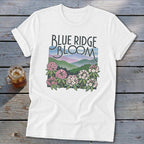 White t-shirt with "Blue Ridge Bloom" text and mountain and flower graphic.