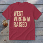 Maroon t-shirt with "WEST VIRGINIA RAISED" text in cream font.