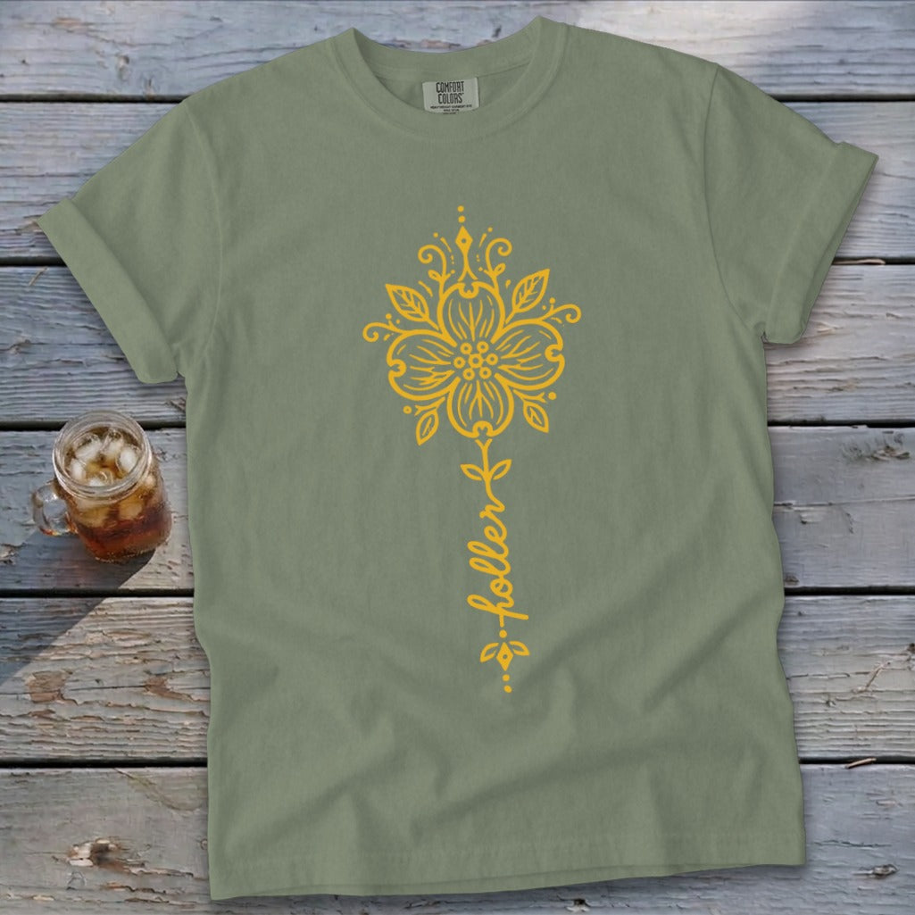 Sage green t-shirt with yellow floral design and "holler" text.
