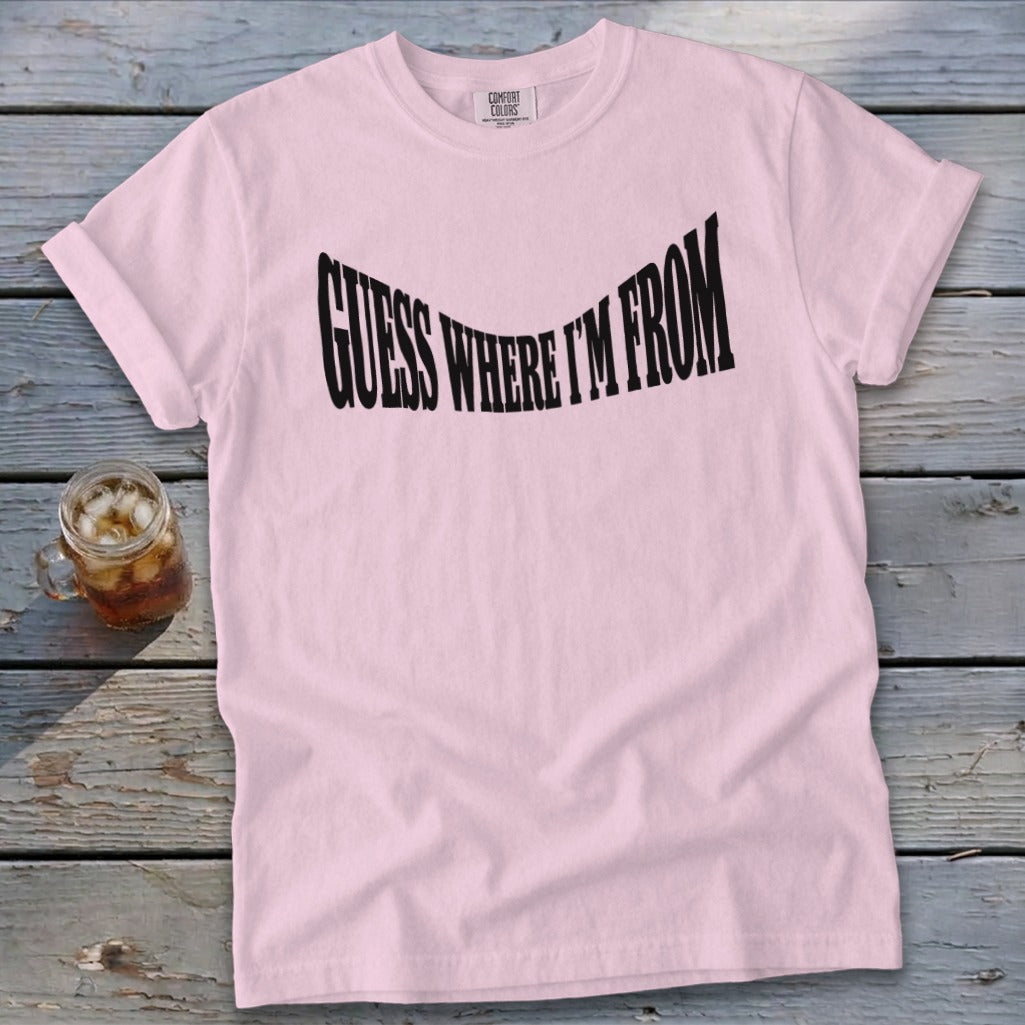 Light pink t-shirt with black text "GUESS WHERE I'M FROM".