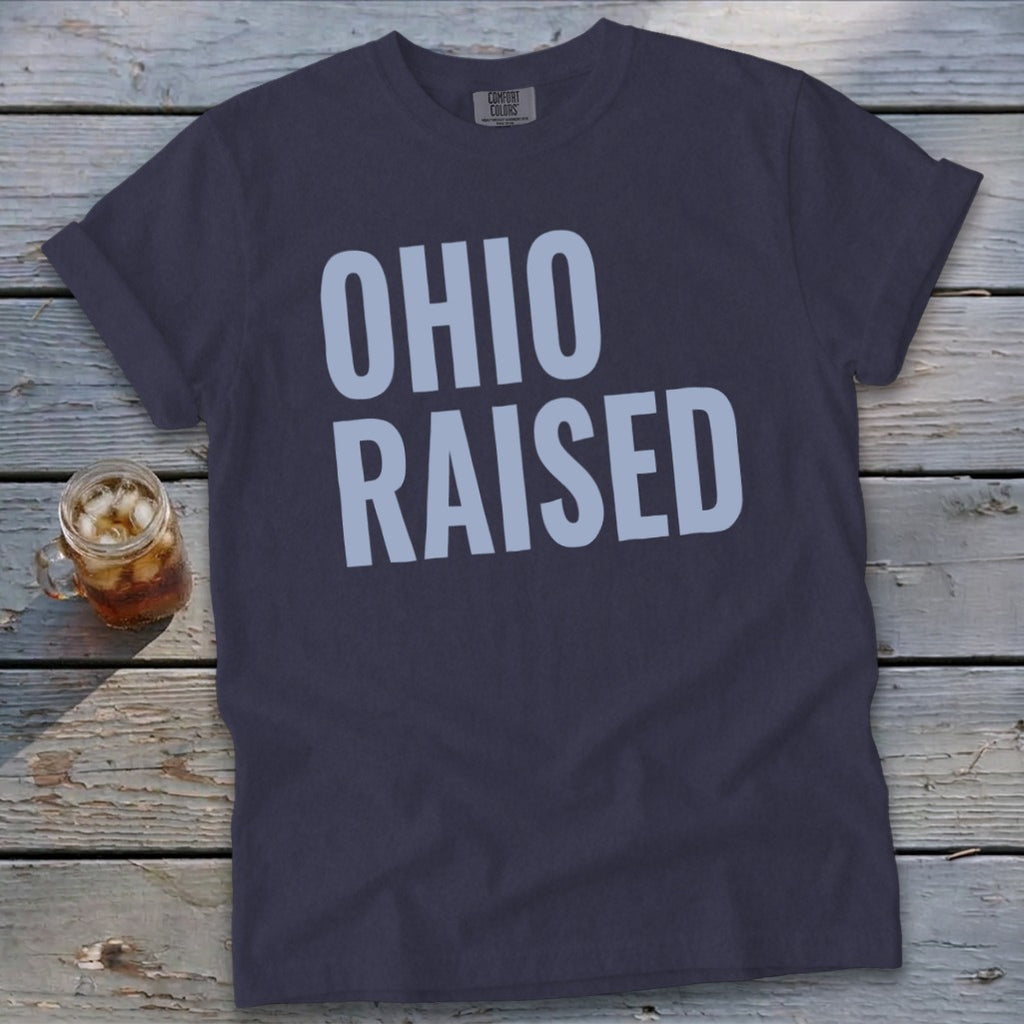 Dark t-shirt with light blue text reading "OHIO RAISED" and a glass of iced tea.