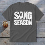A dark gray crewneck t-shirt featuring the distressed white text SANG SEASON, with a silhouetted digger forming the letter A.