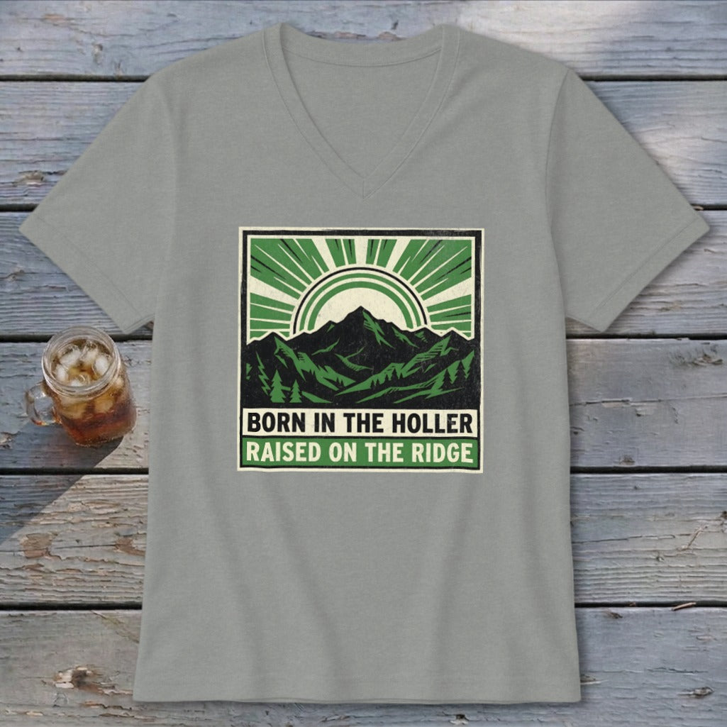 Grey V-neck t-shirt featuring a green graphic of mountains and text that reads Born in the Holler Raised on the Ridge.
