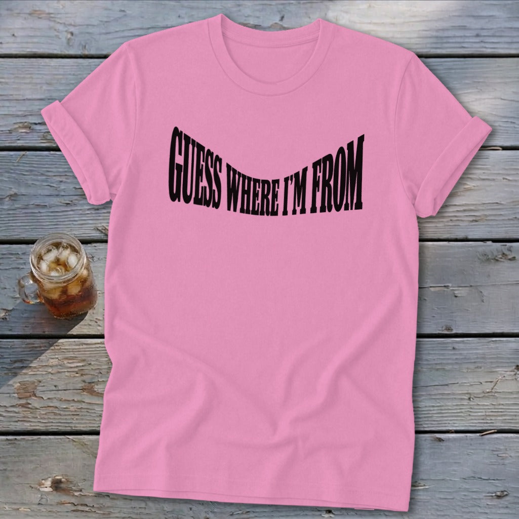 Pink t-shirt with black text that says "GUESS WHERE I'M FROM".