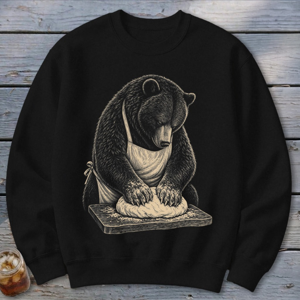Black sweatshirt with a bear in an apron kneading dough on a wooden board.