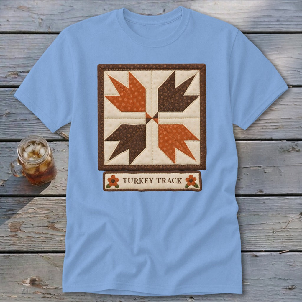 Light blue t-shirt with a square quilt block and "Turkey Track" text.