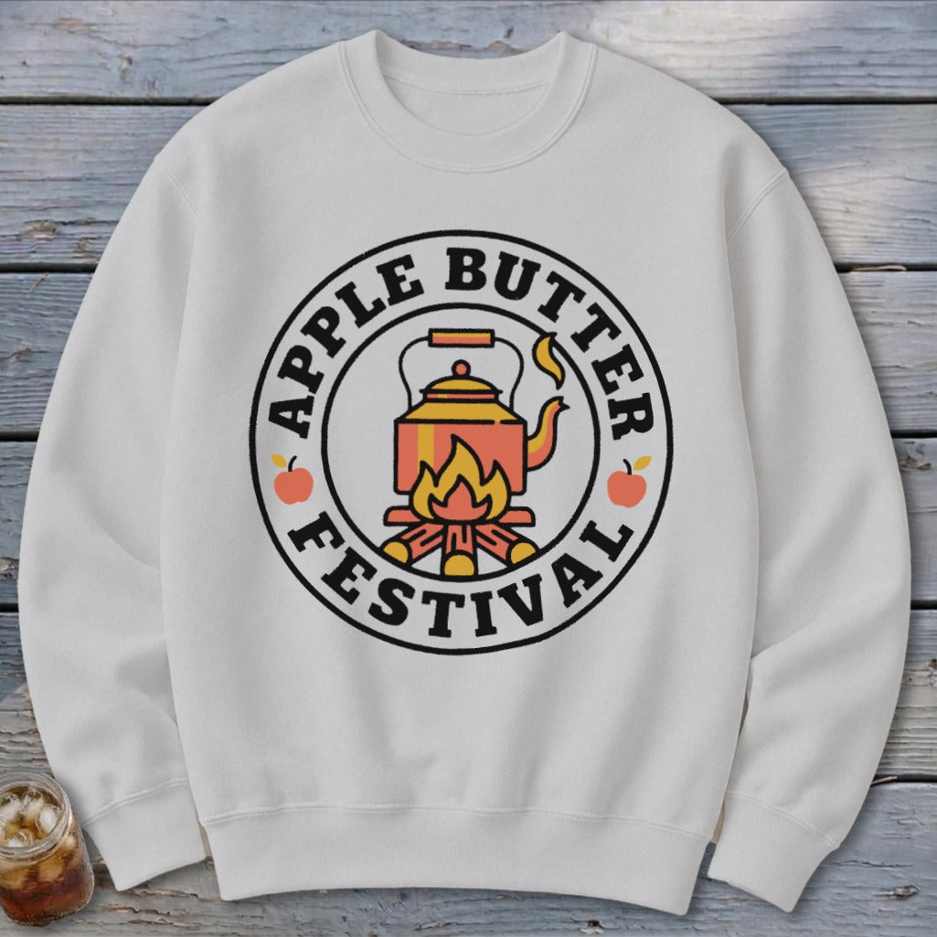 White sweatshirt with "Apple Butter Festival" text and kettle over campfire graphic.