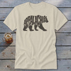 A cream-colored crew neck t-shirt featuring a brown graphic of a bear filled with the word Appalachia.