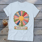 Light blue t-shirt featuring a colorful Dresden Plate quilt block with text.