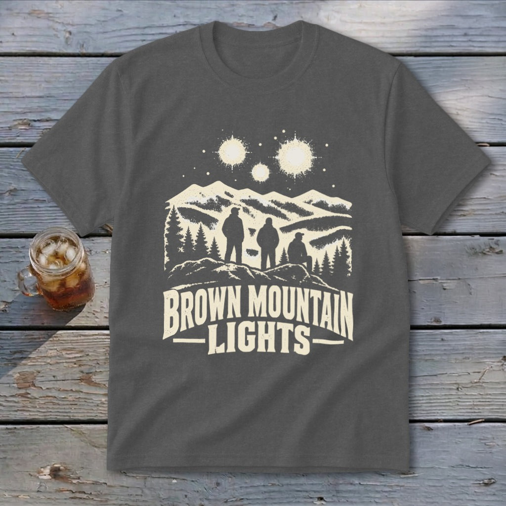 Charcoal gray crewneck t-shirt featuring a cream graphic of three figures, mountains, and glowing lights.