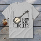 Light grey t-shirt with a banjo illustration and text "BORN IN THE HOLLER".