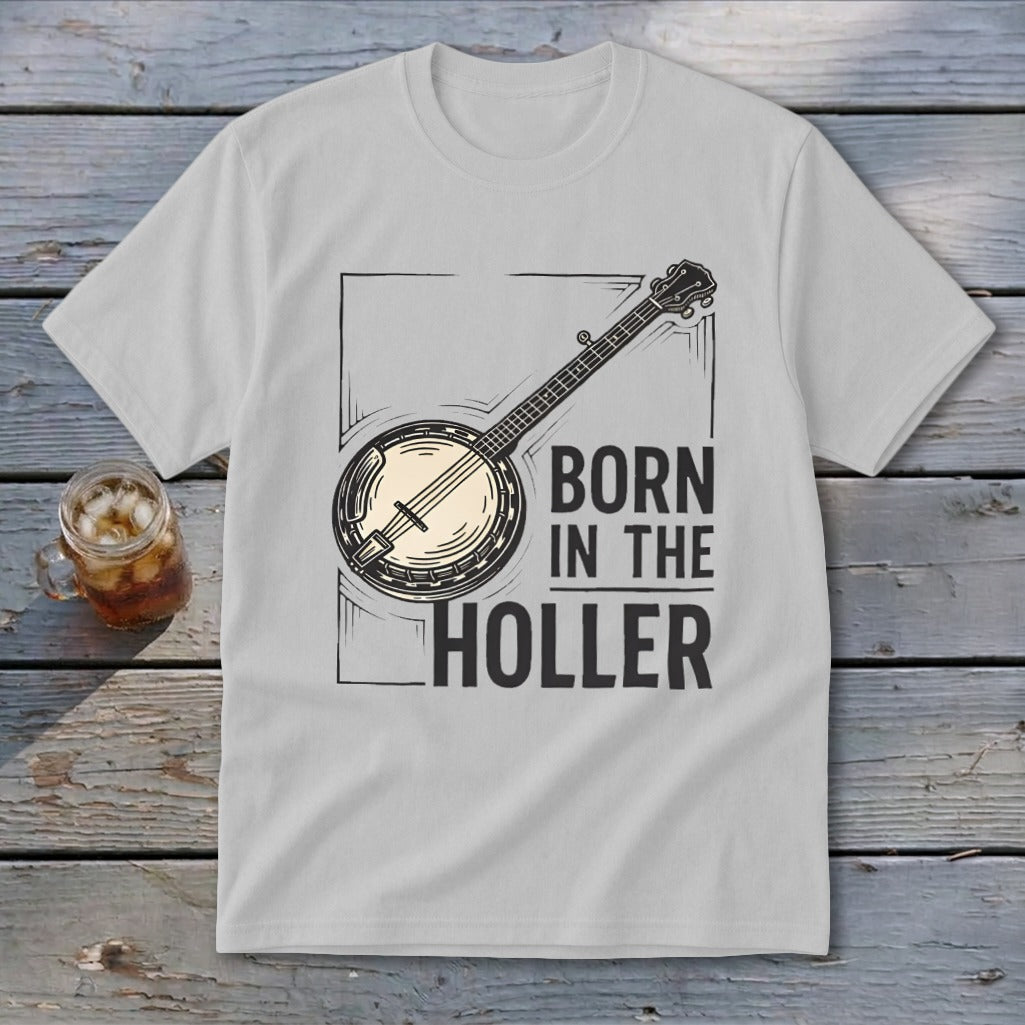 Light grey t-shirt with a banjo illustration and text "BORN IN THE HOLLER".