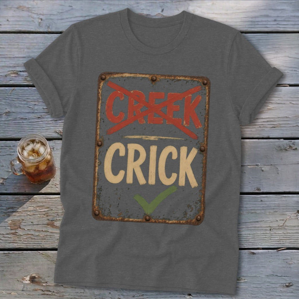 Gray t-shirt with a distressed sign reading "CREEK" crossed out and "CRICK" with a checkmark.