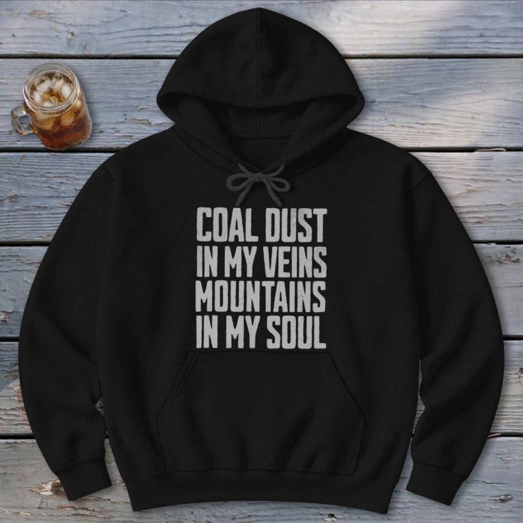 Black hoodie with the distressed white text Coal Dust In My Veins Mountains In My Soul printed on the chest.