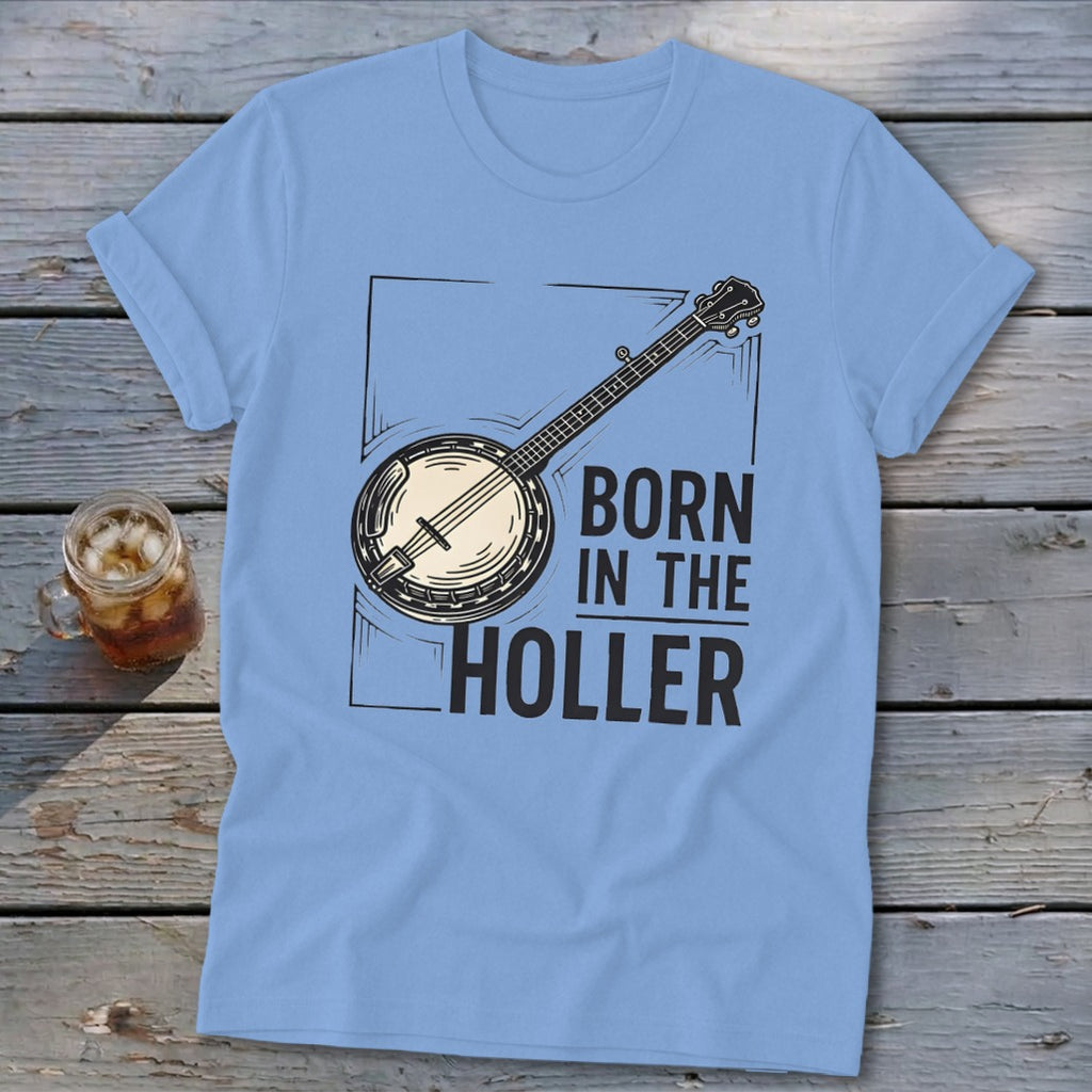 Light blue t-shirt with a banjo graphic and text "BORN IN THE HOLLER".