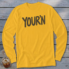 Yellow long-sleeve t-shirt with "YOUR'N" text in dark brown.