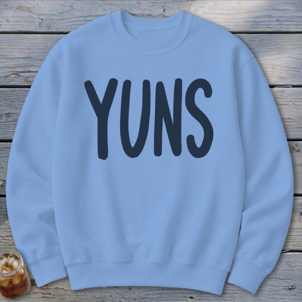 Light blue sweatshirt with "YUNS" printed in dark blue on the front.