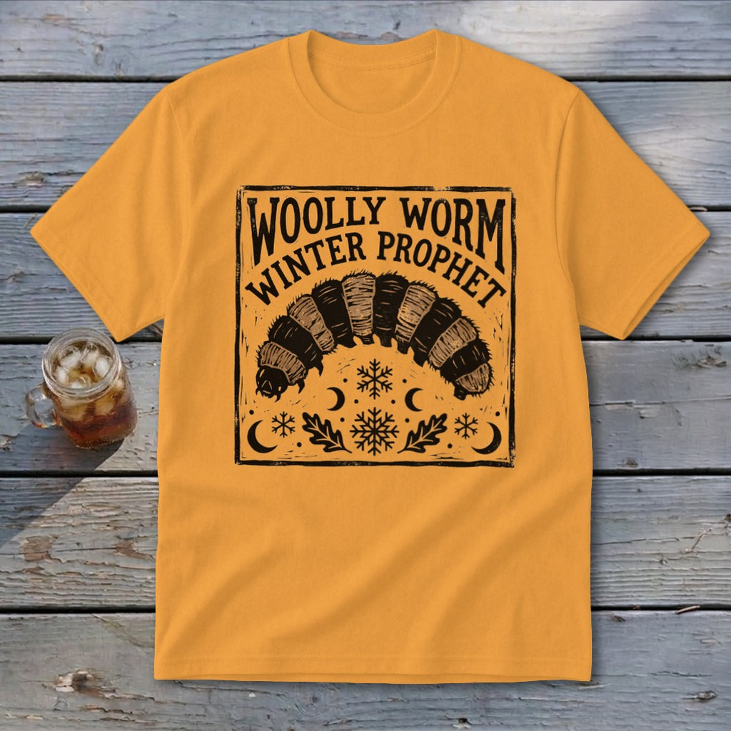 Gold crewneck t-shirt with a block-print graphic of a woolly worm and text reading Woolly Worm Winter Prophet.