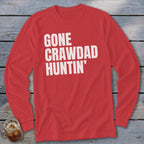 Red long-sleeved shirt with white text "GONE CRAWDAD HUNTIN'".