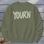 Olive green crewneck sweatshirt with "YOUR'N" in light green text.