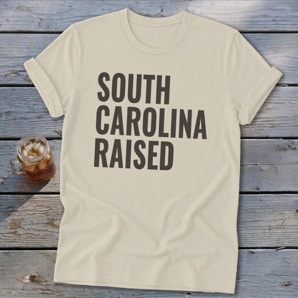 Cream t-shirt with "South Carolina Raised" text in dark gray.