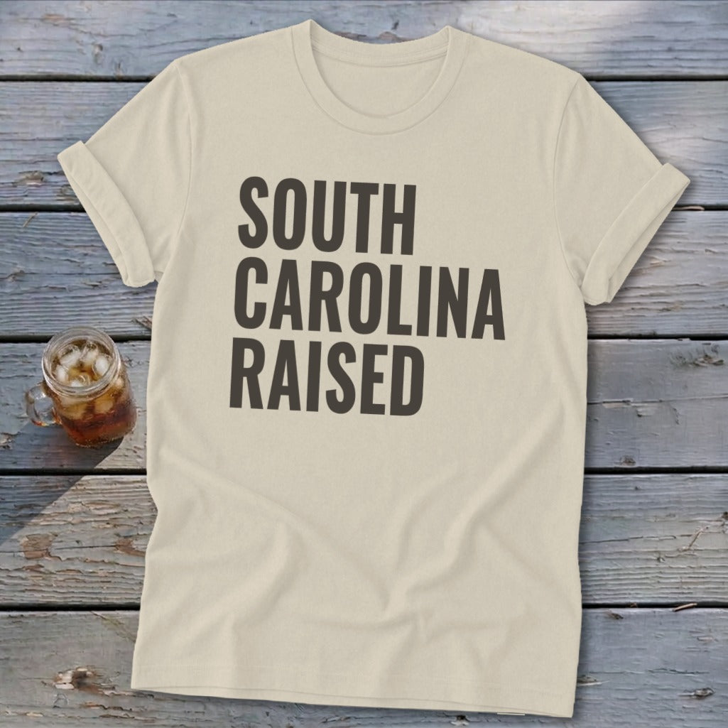 Cream t-shirt with "South Carolina Raised" text in dark gray.