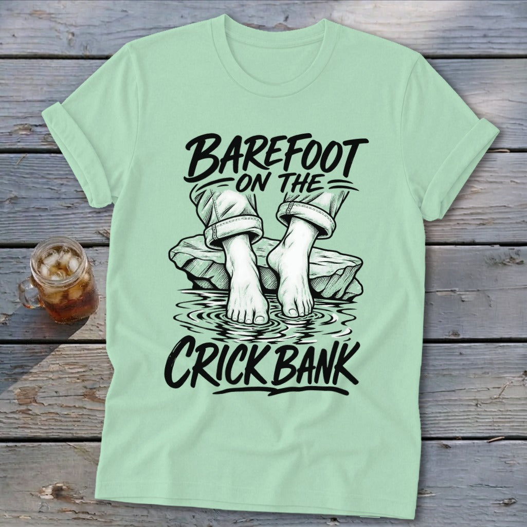 Light green t-shirt with "Barefoot on the Crick Bank" text and graphic.