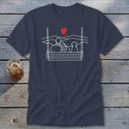 Navy t-shirt with white line art of couple and dog on swing with red heart.