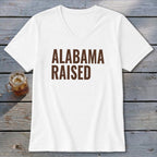 White v-neck t-shirt with "Alabama Raised" printed in brown.