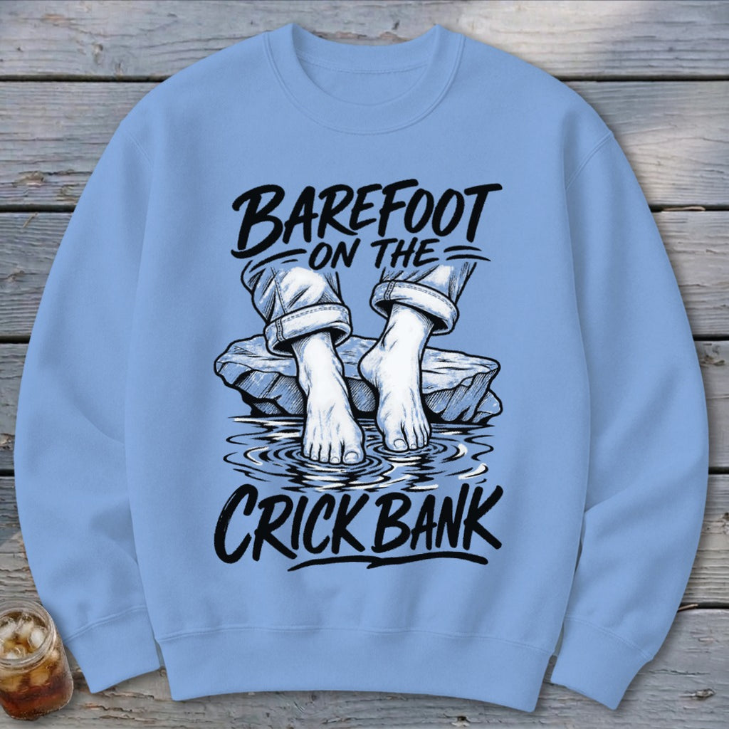 Light blue crewneck sweatshirt with "BAREFOOT ON THE CRICK BANK" text and graphic.