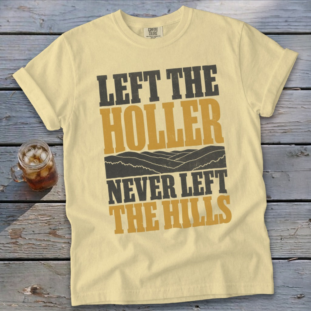 Light yellow t-shirt with "LEFT THE HOLLER NEVER LEFT THE HILLS" text.