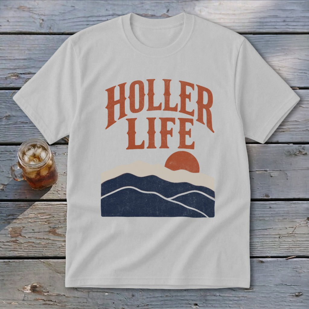 Light gray t-shirt with orange text reading HOLLER LIFE above a sunset landscape graphic.