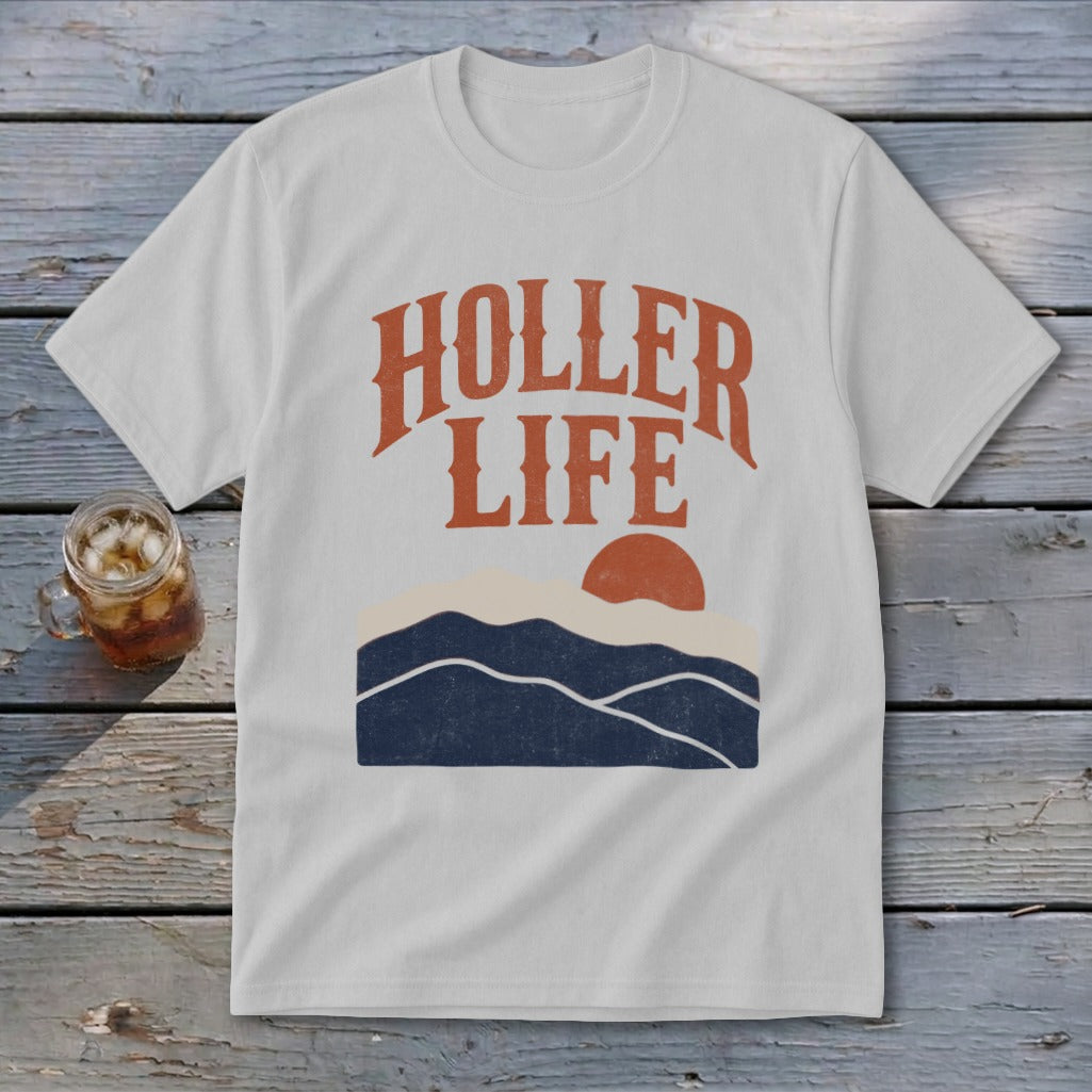 Light gray t-shirt with orange text reading HOLLER LIFE above a sunset landscape graphic.