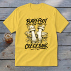 Yellow t-shirt with "Barefoot on the Creek Bank" text and graphic.