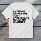 White t-shirt with black text "Anymore people just don't understand mountain grammar."