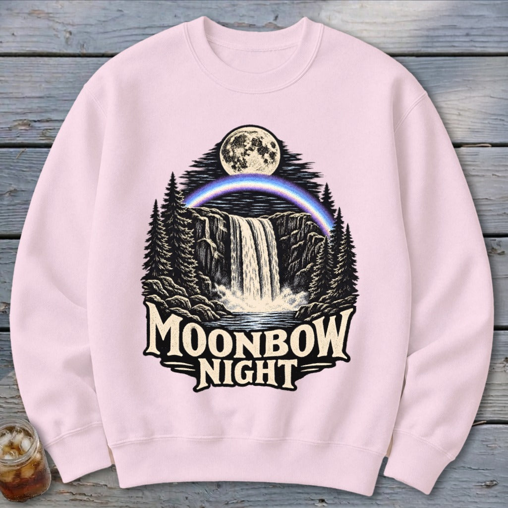 Pink sweatshirt with "Moonbow Night" graphic of waterfall, moon, and rainbow.