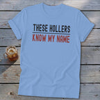 Light blue t-shirt with "THESE HOLLERS KNOW MY NAME" text.