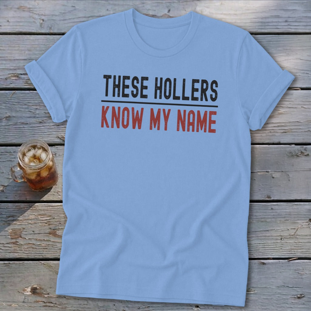 Light blue t-shirt with "THESE HOLLERS KNOW MY NAME" text.