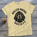 Yellow t-shirt with black "Holler Hound Society" text and dog graphic.