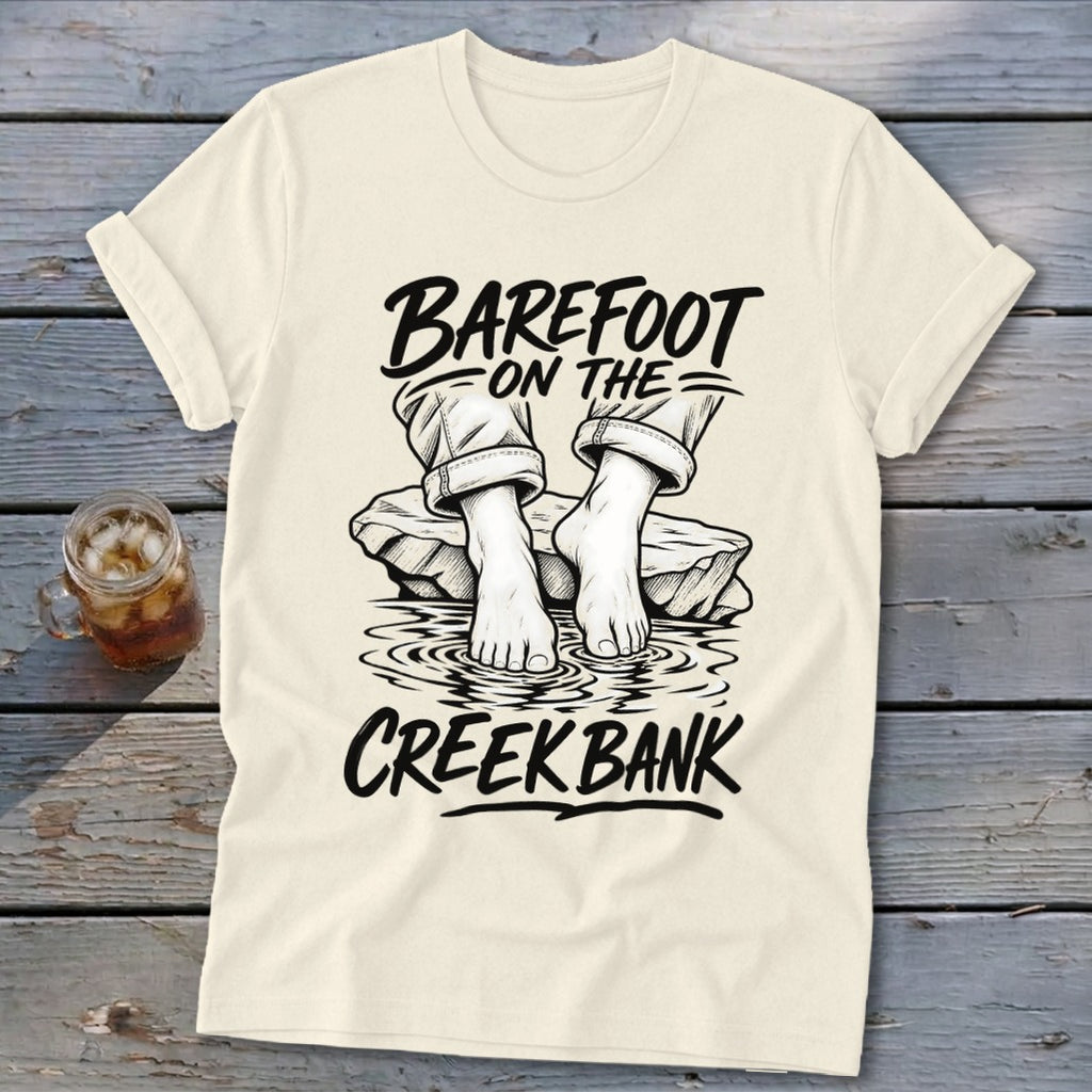 Cream t-shirt with black text and graphic of bare feet in water.